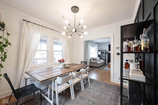 dining room featuring crown molding, a chandelier, and dark hardwood / wood-style flooring