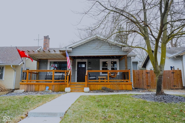 view of front of property featuring a pergola, a front yard, and a porch