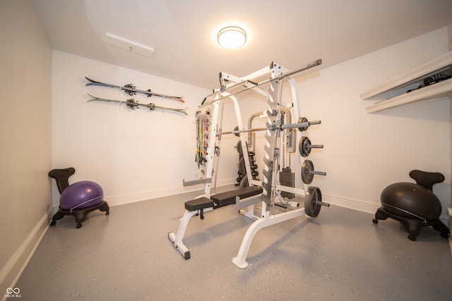 workout room featuring baseboards