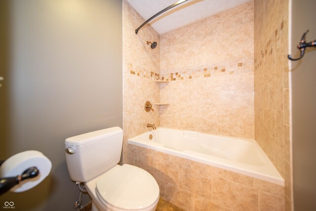 full bath with toilet and tiled shower / bath