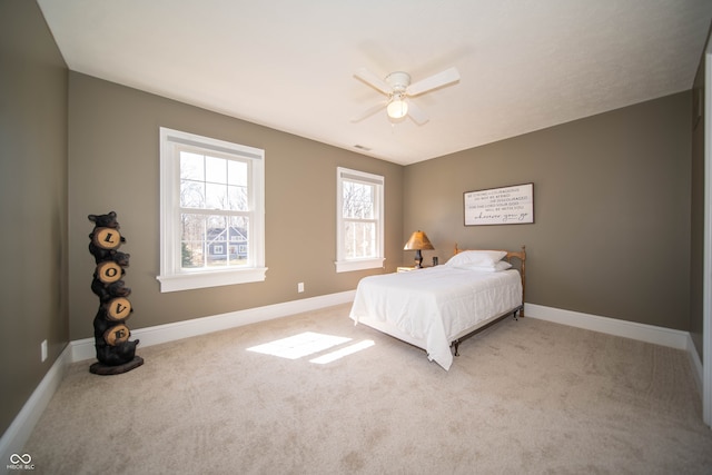 bedroom featuring baseboards, ceiling fan, and carpet flooring