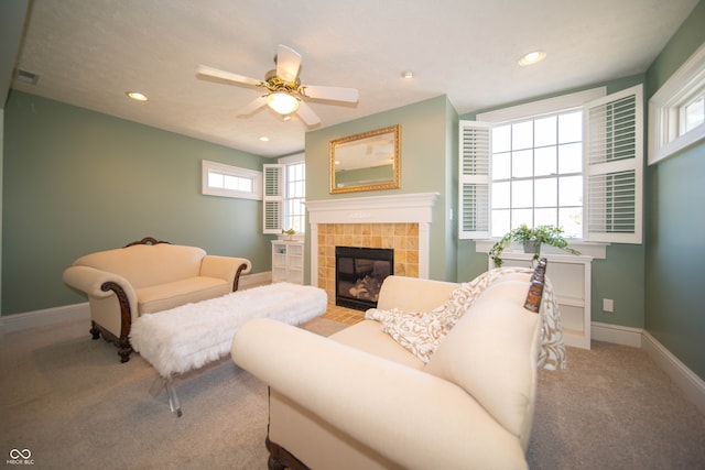 carpeted living room featuring visible vents, baseboards, ceiling fan, recessed lighting, and a fireplace