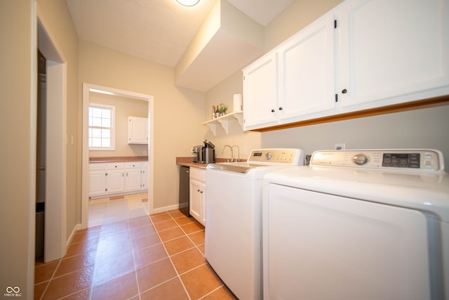 washroom with light tile patterned flooring, cabinet space, independent washer and dryer, and baseboards