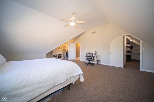 carpeted bedroom with a closet, visible vents, a walk in closet, and baseboards