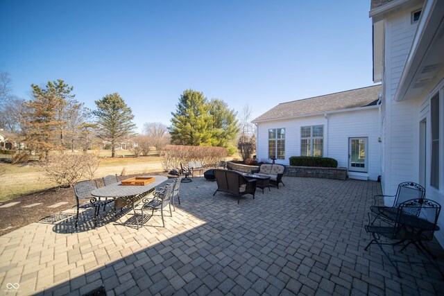 view of patio featuring an outdoor living space with a fire pit