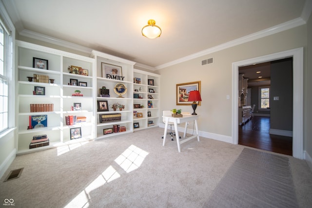 interior space featuring crown molding, carpet flooring, baseboards, and visible vents