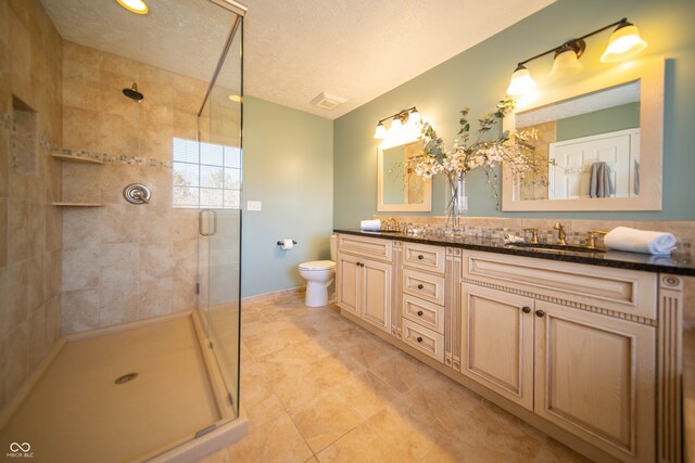 full bath featuring double vanity, a shower stall, and a sink