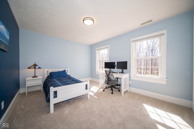 bedroom featuring visible vents, carpet flooring, and baseboards