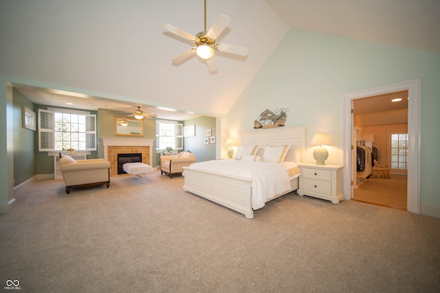 bedroom with baseboards, light carpet, a fireplace, high vaulted ceiling, and a ceiling fan