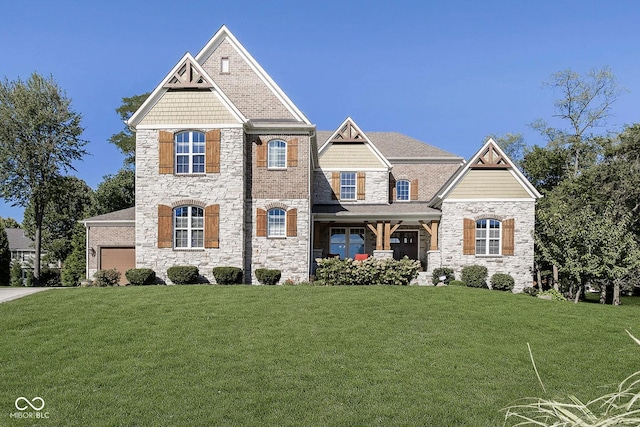 craftsman house featuring a garage and a front lawn