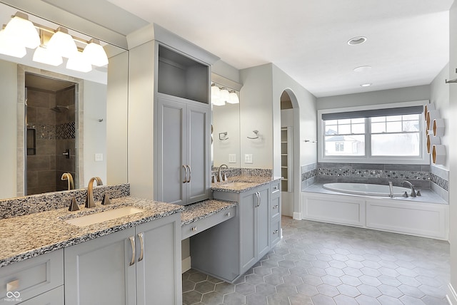 bathroom featuring separate shower and tub and vanity