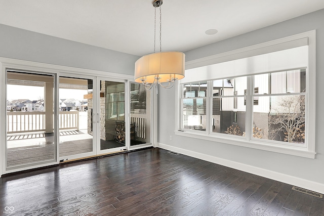 unfurnished dining area with dark hardwood / wood-style floors