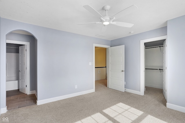 unfurnished bedroom with carpet, a closet, and ceiling fan