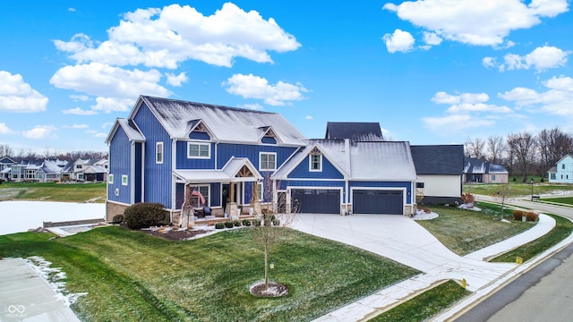 view of front of property featuring a front yard and a garage