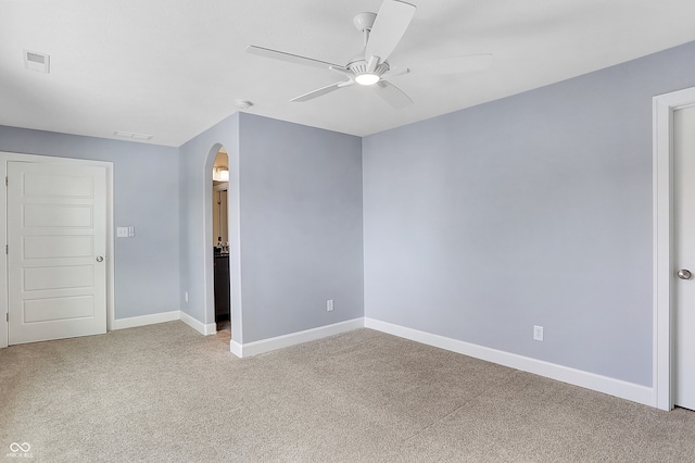 unfurnished room featuring ceiling fan and light colored carpet