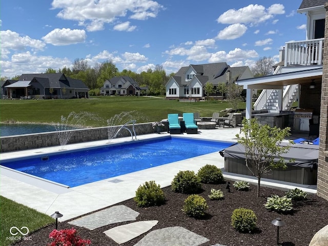 view of swimming pool featuring a yard, a patio, an outdoor fire pit, and pool water feature