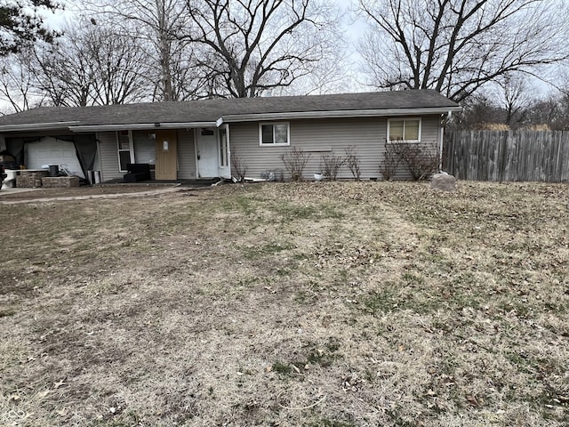 ranch-style home featuring a garage and fence