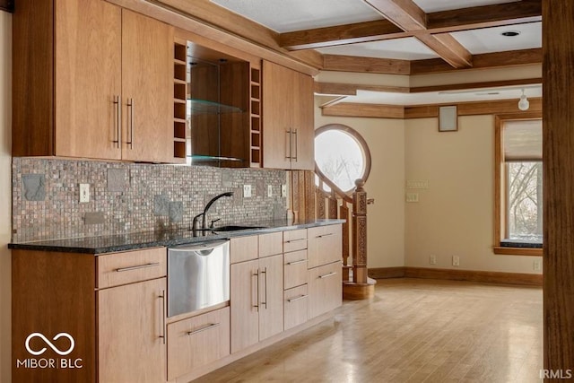 kitchen featuring dark stone counters, sink, dishwasher, coffered ceiling, and light brown cabinetry