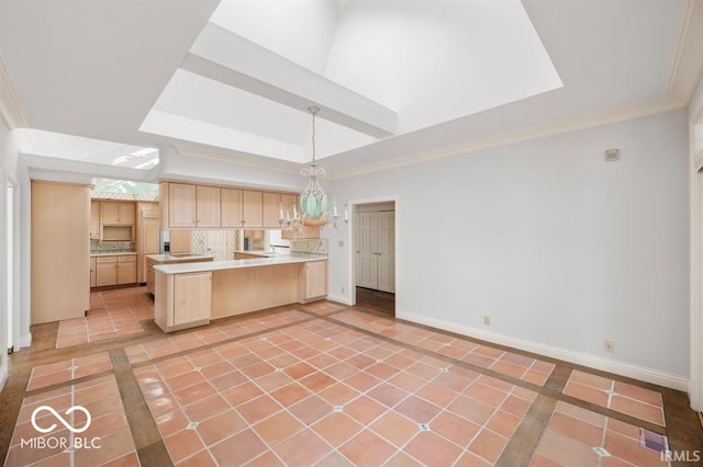 kitchen featuring light tile patterned flooring, a tray ceiling, light brown cabinetry, kitchen peninsula, and hanging light fixtures