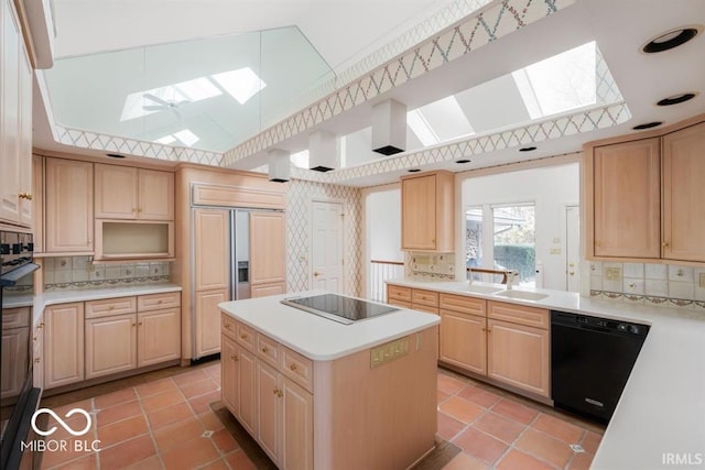 kitchen with a center island, sink, black appliances, and a skylight