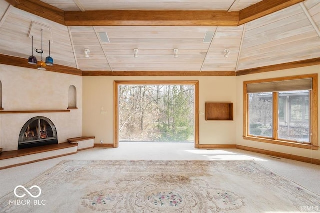 unfurnished living room featuring plenty of natural light, carpet floors, and lofted ceiling