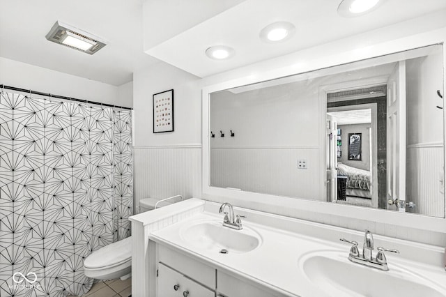 bathroom with toilet, vanity, and walk in shower