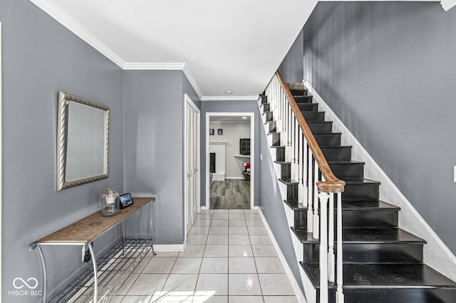 entryway with ornamental molding, a brick fireplace, and light tile patterned flooring