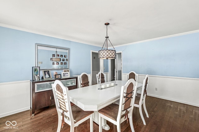 dining area featuring ornamental molding and dark hardwood / wood-style flooring