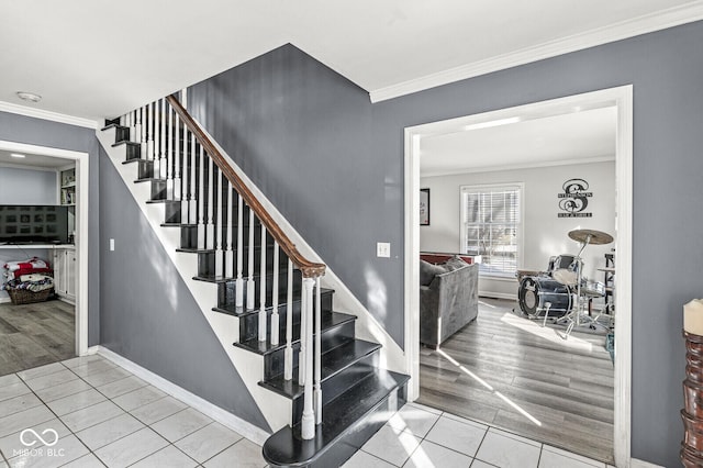 stairway with crown molding and tile patterned flooring