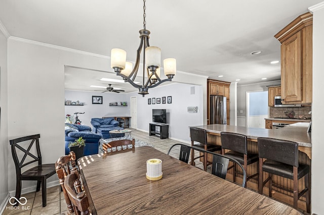 dining area featuring ceiling fan, ornamental molding, and light tile patterned floors