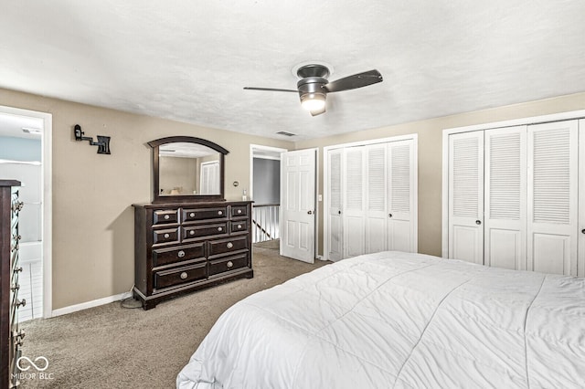 bedroom featuring ceiling fan, two closets, and carpet floors