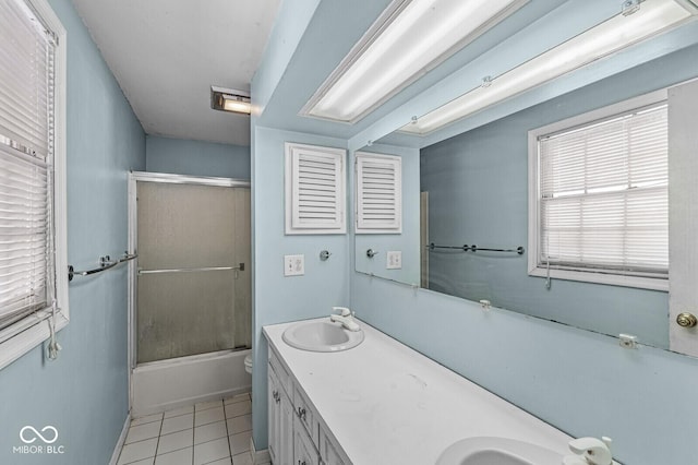 full bathroom with shower / bath combination with glass door, tile patterned flooring, vanity, and toilet