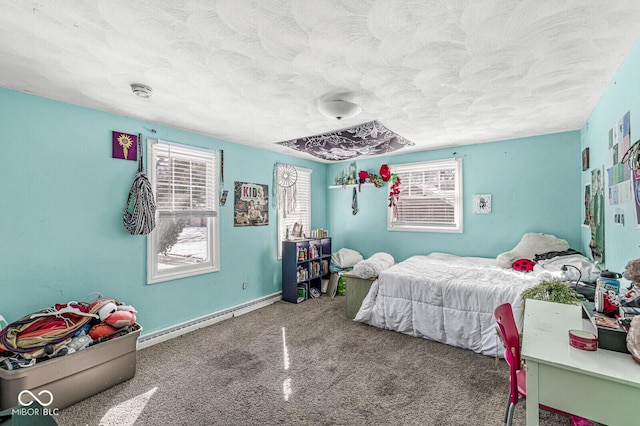 carpeted bedroom with multiple windows, a textured ceiling, and baseboard heating