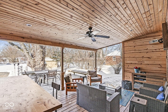 snow covered deck featuring outdoor lounge area and ceiling fan