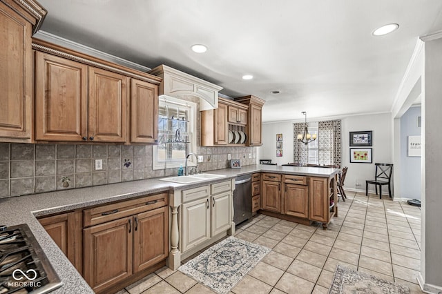 kitchen featuring hanging light fixtures, a wealth of natural light, sink, stovetop, and dishwasher