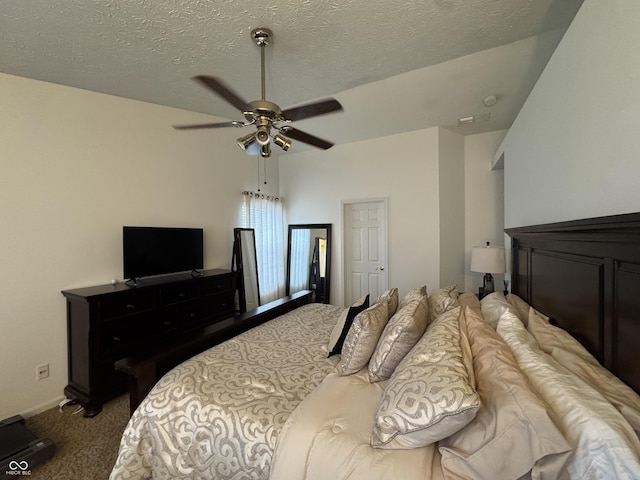 carpeted bedroom with a textured ceiling and ceiling fan