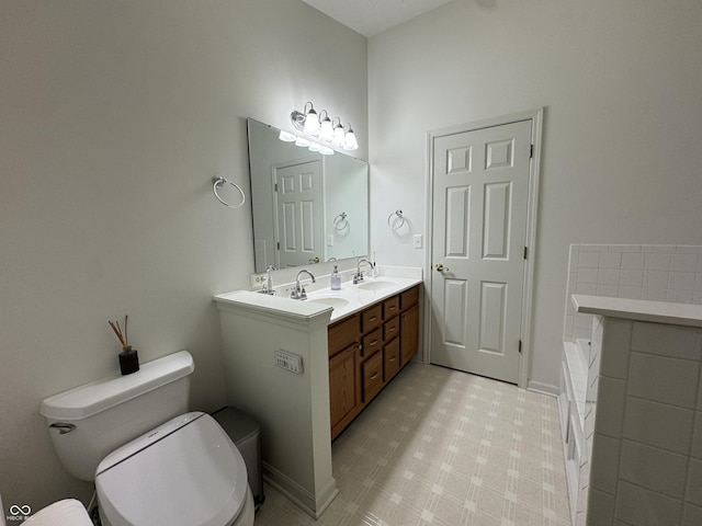 bathroom featuring a tub, toilet, and vanity