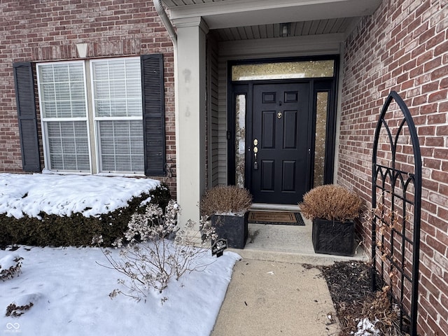 view of snow covered property entrance