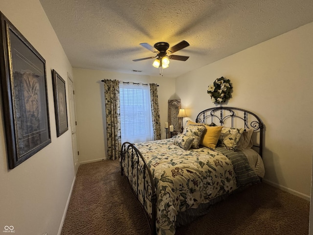 carpeted bedroom with ceiling fan and a textured ceiling