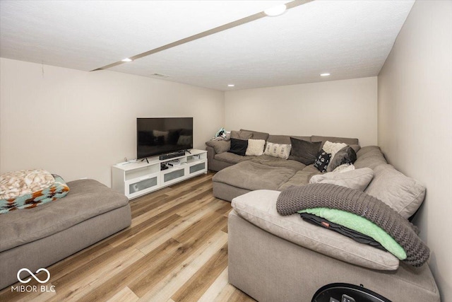 living room featuring recessed lighting, visible vents, and light wood finished floors