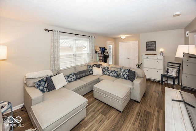 living room with dark wood-type flooring and baseboards