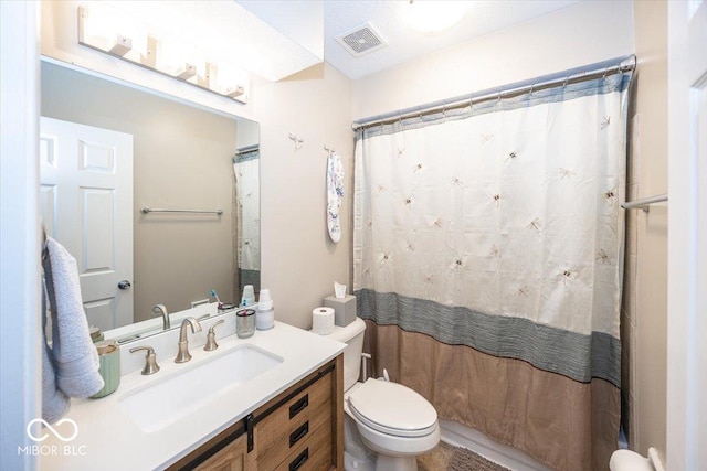 bathroom featuring visible vents, toilet, vanity, and a shower with shower curtain