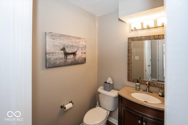 bathroom featuring toilet and vanity