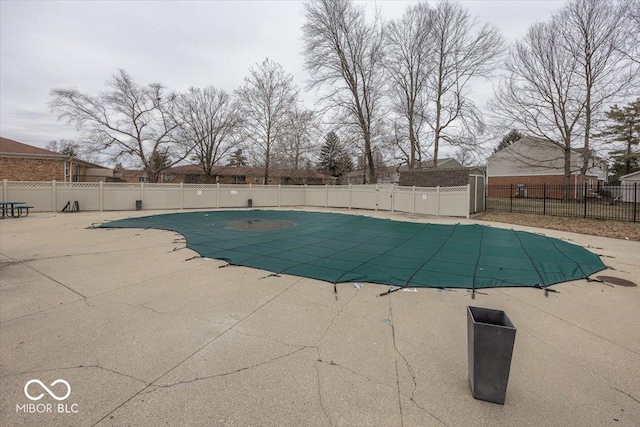 view of swimming pool with a patio area, a fenced in pool, and fence