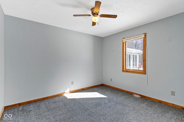 carpeted spare room with ceiling fan and a textured ceiling