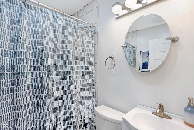 bathroom with sink, a shower with curtain, and toilet