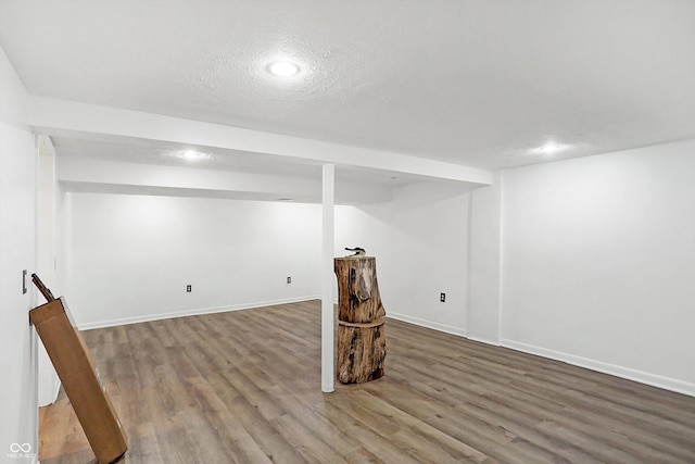 basement with a textured ceiling and hardwood / wood-style flooring