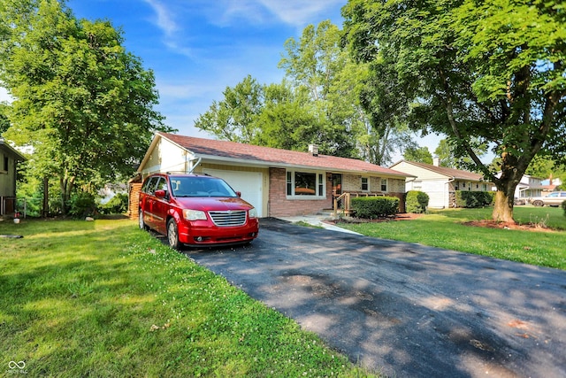 ranch-style house featuring a front yard and a garage