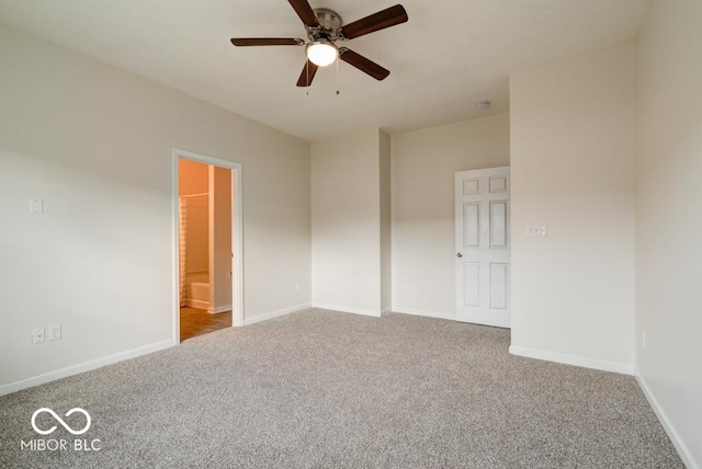 empty room with baseboards, a ceiling fan, and light colored carpet