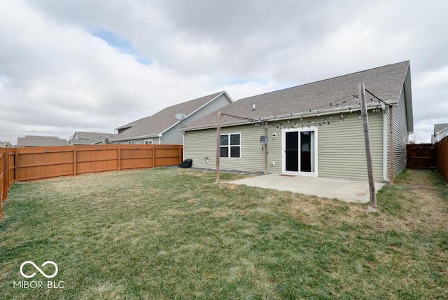 back of property with a patio, a yard, and a fenced backyard